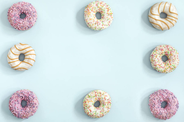 Collection of glazed donuts on pastel blue background - Foto, imagen