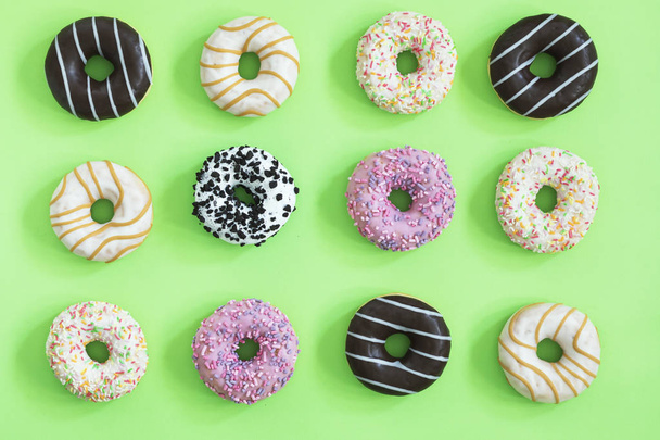 Collection of glazed donuts on pastel green background - Foto, Imagen