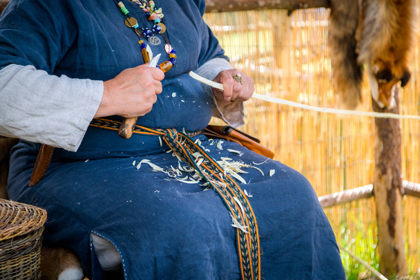 Women carpenter wearing rural clothing and carving a wooden stick, woodwork - Φωτογραφία, εικόνα