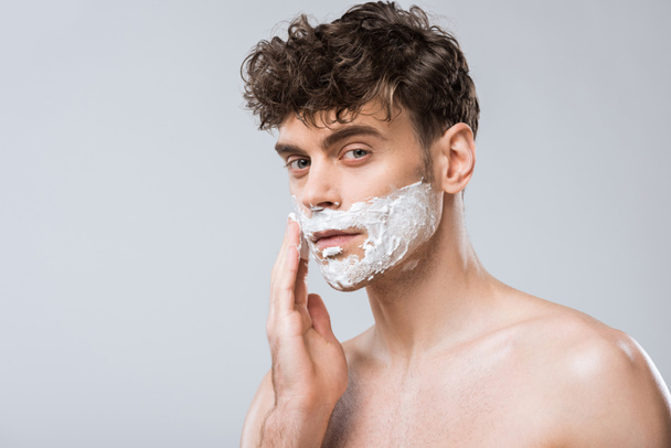 handsome man applying shaving foam on face, isolated on grey - Photo, Image