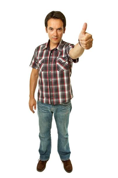 Young casual man going thumb up in a white background - Photo, Image