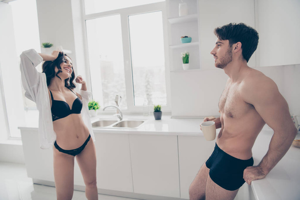 Close up side profile view photo of two people pair prelude honeymoon she her lady take he him his shirt off naughty watch tea coffee beverage hand arm look wish striptease never stop provocative - Фото, изображение
