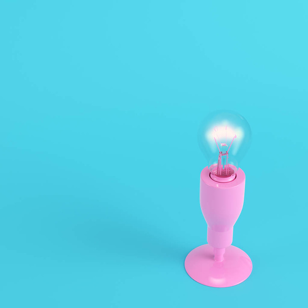 Pink lamp with glowing light bulb on bright blue background in pastel colors. Minimalism concept. 3d render - Zdjęcie, obraz