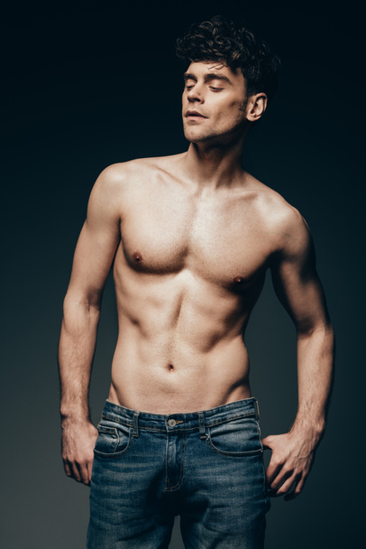 sexy shirtless muscular man in jeans posing isolated on dark grey - Zdjęcie, obraz