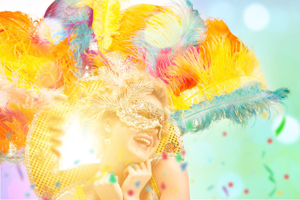 Beautiful young woman in carnival mask - 写真・画像