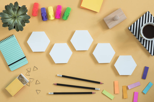 Creative desk with white mock up hexagon shapes of diagram on pastel background  - Фото, зображення