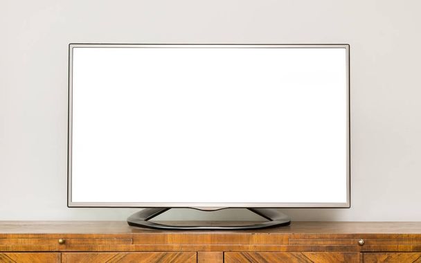 Плоский РК-телевізор на коричневому дерев'яному шафі у вітальні з білим екраном для копіювання тексту
  - Фото, зображення
