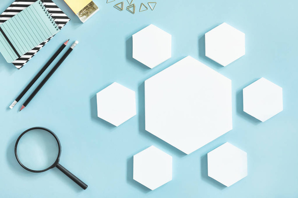 Creative desk with white mock up hexagon shapes of diagram on pastel background  - Fotó, kép