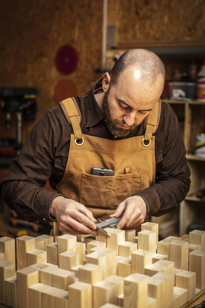 caucasian carpenter at work in his workshop - 写真・画像