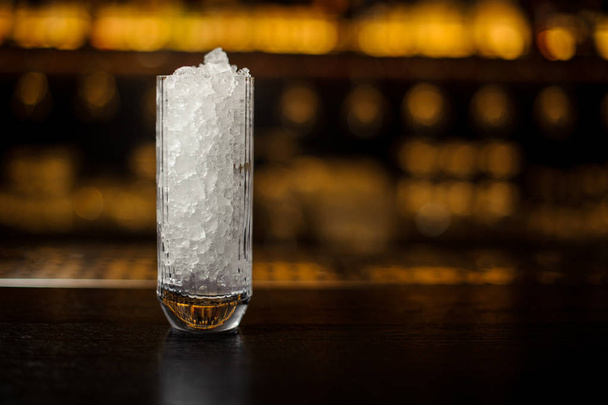 High glass with ice cubes on the bar counter of restaurant - Φωτογραφία, εικόνα