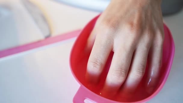 Female hand in bowl with water before manicure - Footage, Video