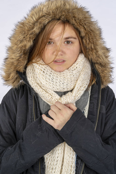 Stüdyo ortamında kışlık ceketle poz veren güzel sarışın bir genç model. - Fotoğraf, Görsel