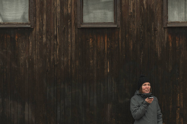 Mobile phone conversation on street in winter, adult caucasian woman talking on telephone - Fotografie, Obrázek