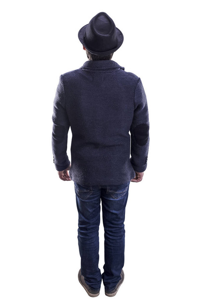 man with hat and jacket stands with his back to the viewer, isolated on white background - Foto, immagini