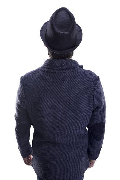 man with hat and jacket stands with his back to the viewer, isolated on white background - Foto, Bild