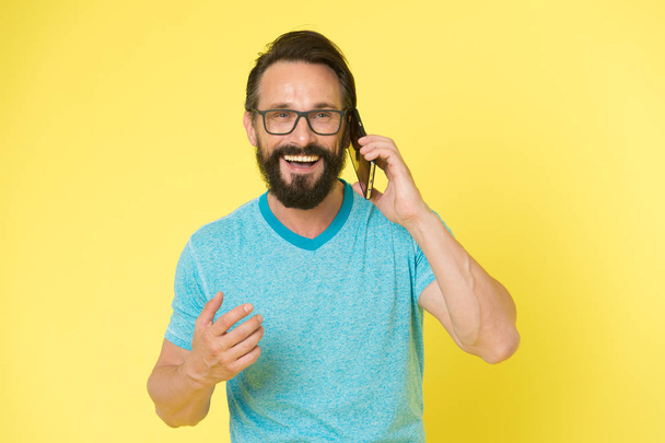 brutal caucasian hipster with moustache. happy conversation. Business. Bearded man speaking on phone. modern life with digital technology. Mature hipster with beard. Confident and handsome Brutal man - Photo, image