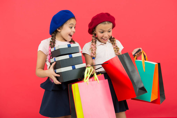 Child cute small girls on shopping tour. Best price. Buy now. Visit shopping mall. Kids girls hold bunch shopping bags or birthday gifts packages. Dreams come true. Happy childhood. Shopping concept - Fotografie, Obrázek