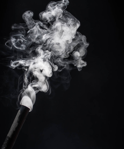 Smoke from a pipe on a black background . - Photo, Image