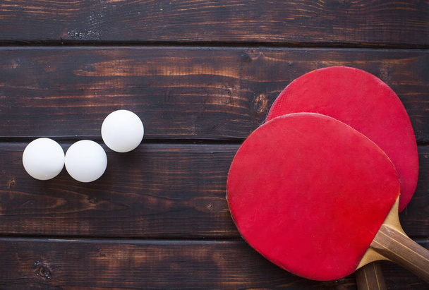 Sport fitness, weight loss concept. Ping pong racket, balls on dark wooden background. Vintage retro instagram filter - Фото, изображение