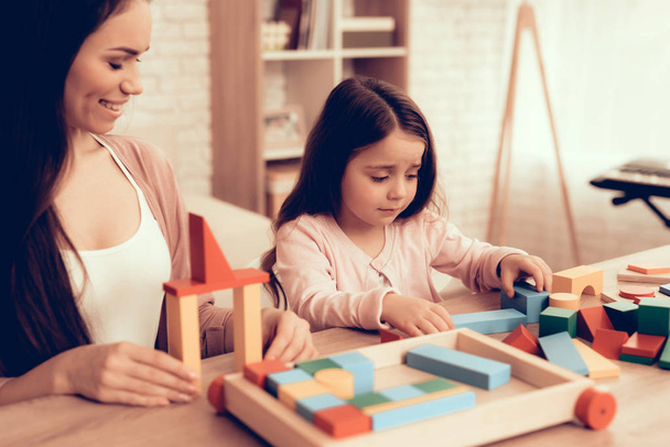 Woman and Girl Build House Colored Cubes on Table. - Fotografie, Obrázek