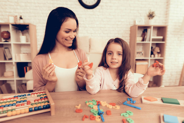 Happy Mother and Daughter Learn Alphabet at Home. - 写真・画像