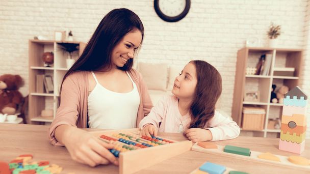 Happy Woman with Board Game Teaches Child at Home. - Foto, Bild