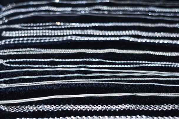 Silver chains on a black background. - Photo, Image
