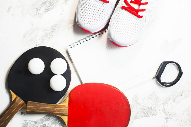 Sport fitness, weight loss concept. Ping pong racket, balls, notepad, sneakers on white wooden background. Vintage retro instagram filter - Valokuva, kuva