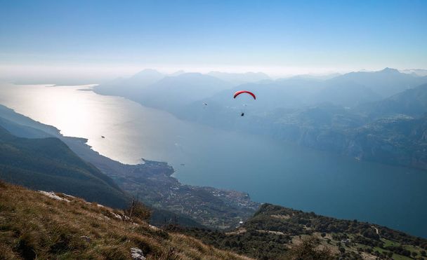 View on Garda lake and paragliders from the mountain Monte Baldo, Malcesine, Lombardy, Italy. - Zdjęcie, obraz