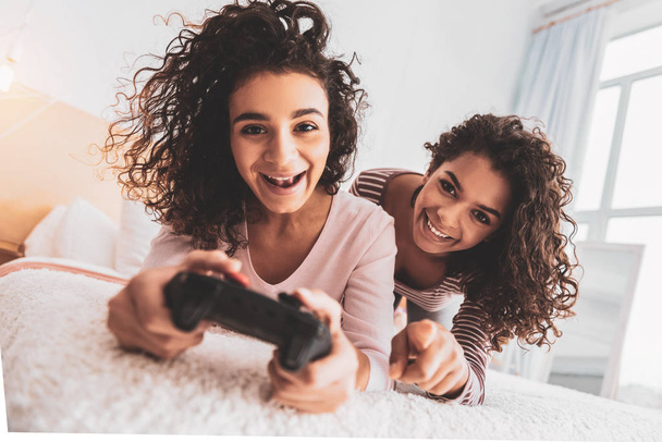 Friends laughing while spending free time with play station - Φωτογραφία, εικόνα