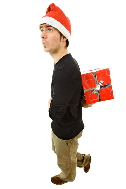 Young man with santa hat holding a gift - Foto, Imagen