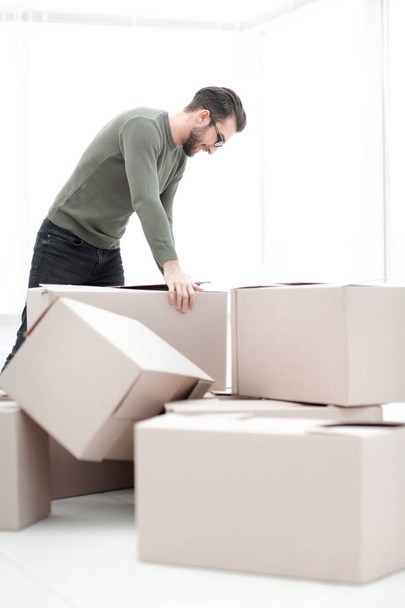 confident man unpacking boxes in the new house - 写真・画像