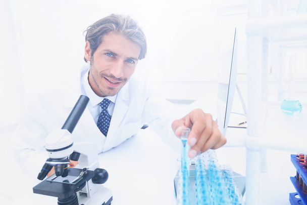 laboratory scientist working in a laboratory with a microscope - Foto, imagen