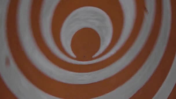 Orange spinning hypnotic wheel close up. Hypnosis Spirals is a way of entering trance or using hypnosis scripts. Hypnotic effect achieved while disc is rotating. Optical visual illusion moving disk - Footage, Video