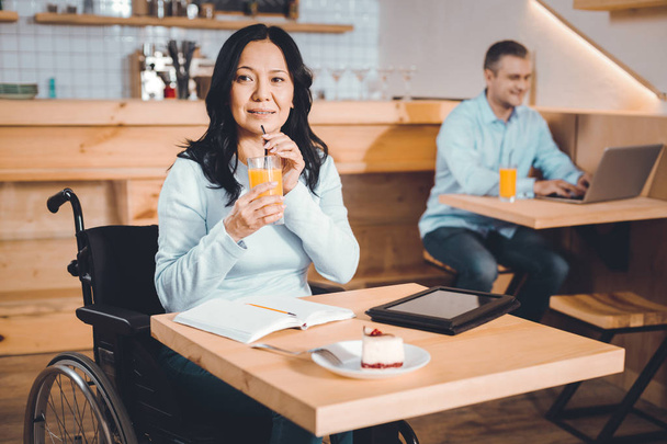 Thoughtful lady drinking juice in a cafe - Фото, зображення