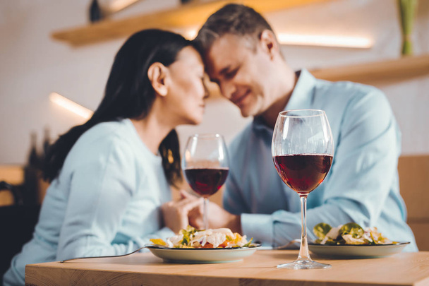 Dreaming couple drinking wine in a restaurant - Fotoğraf, Görsel