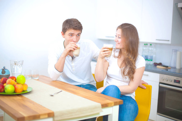 happy young couple in love drinking latte at kitchen  - Φωτογραφία, εικόνα