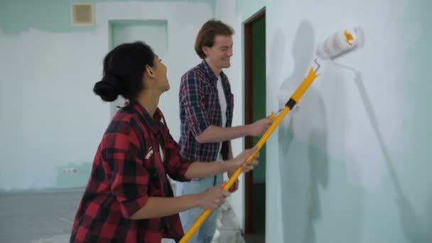 Family painting interior wall with paint rollers - Footage, Video