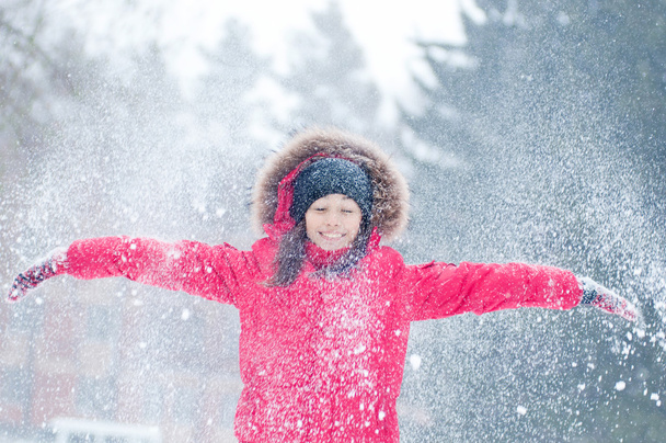 Happy young woman plays with a snow - 写真・画像