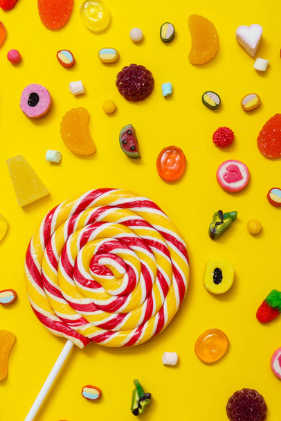 colorful candies on the yellow background - Foto, imagen
