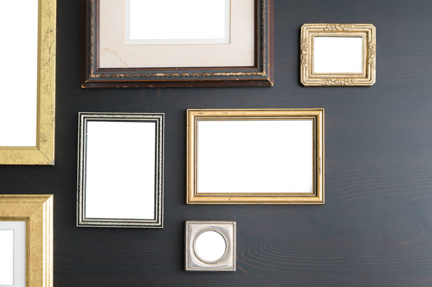 Blank empty frames on dark wooden background. Art gallery, museum exhibition white clipping path - Photo, Image