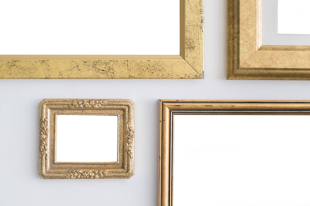 Blank empty golden frames on white background. Art gallery, museum exhibition white clipping path - Фото, изображение
