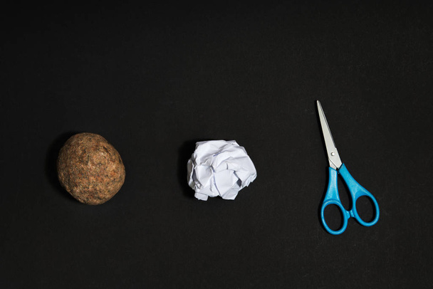Rock, paper, scissors concept. Choice, decision making. Top above view on dark wooden background - Photo, Image