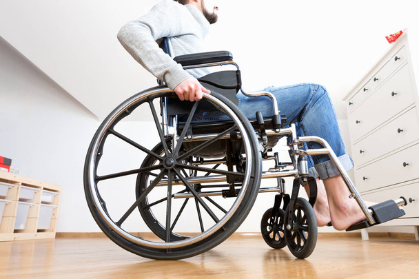 Handicapped man in wheelchair at home.  - Fotoğraf, Görsel