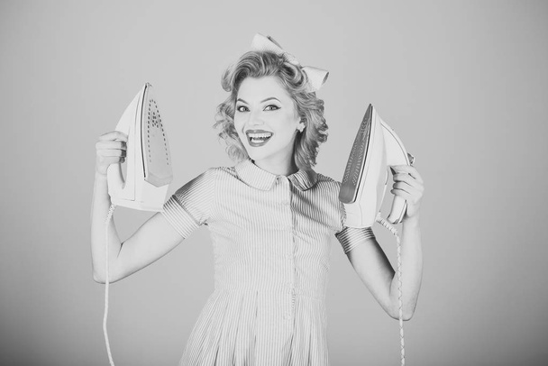 Pinup woman hold iron, retro style, maid. - Foto, Imagen