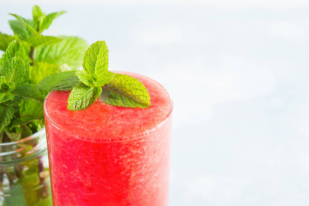 Glass of fresh watermelon drink with mint, closeup view with copy space - 写真・画像