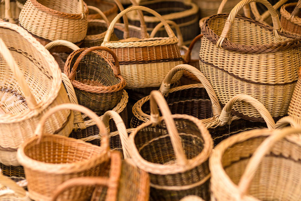 Hand made wicker woven baskets on display in a city fare. Handmade crafts - Photo, Image