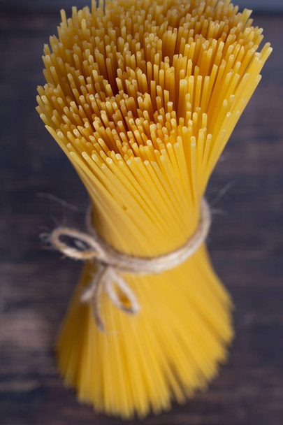 spaghetti closeup on a wooden table - Foto, afbeelding