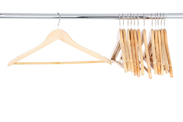 Wooden hangers hanging on white background - Fotó, kép