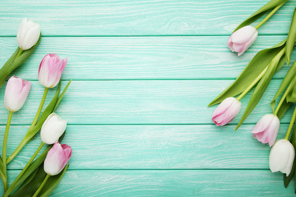 Bouquet of tulips on mint wooden table  - Foto, Imagen